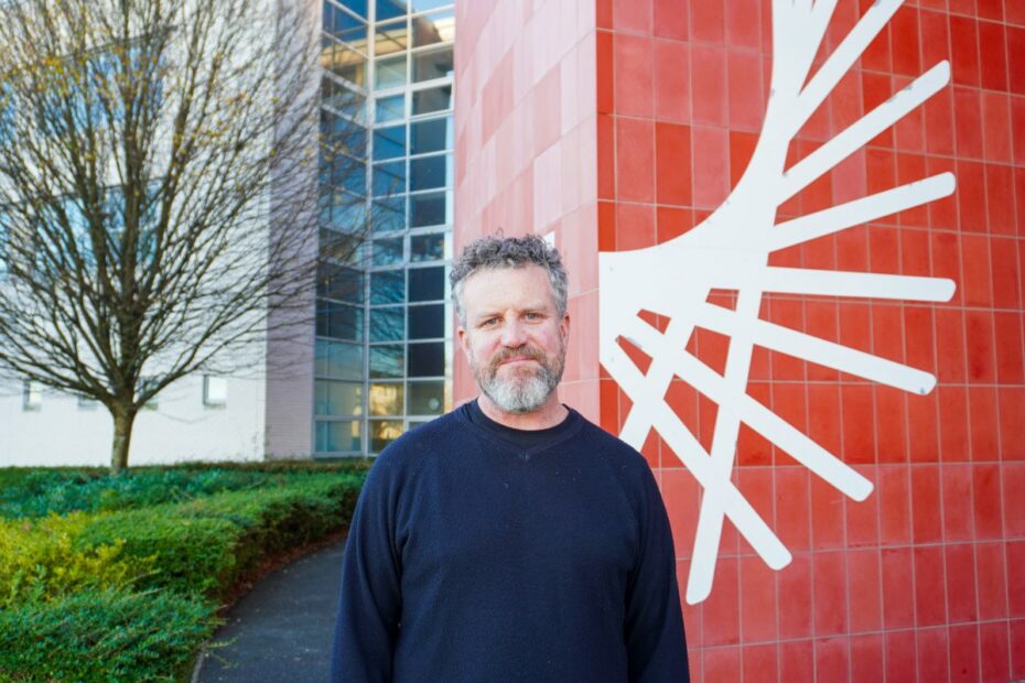 Rob O'Connor stands in front a large building on SETU's campus.