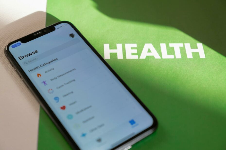 a mobile phone with health and wellness apps installed on a green folder that says health
