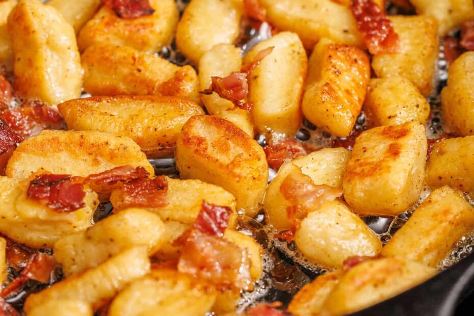 browned ricotta gnocchi recipe in a saute pan with bacon